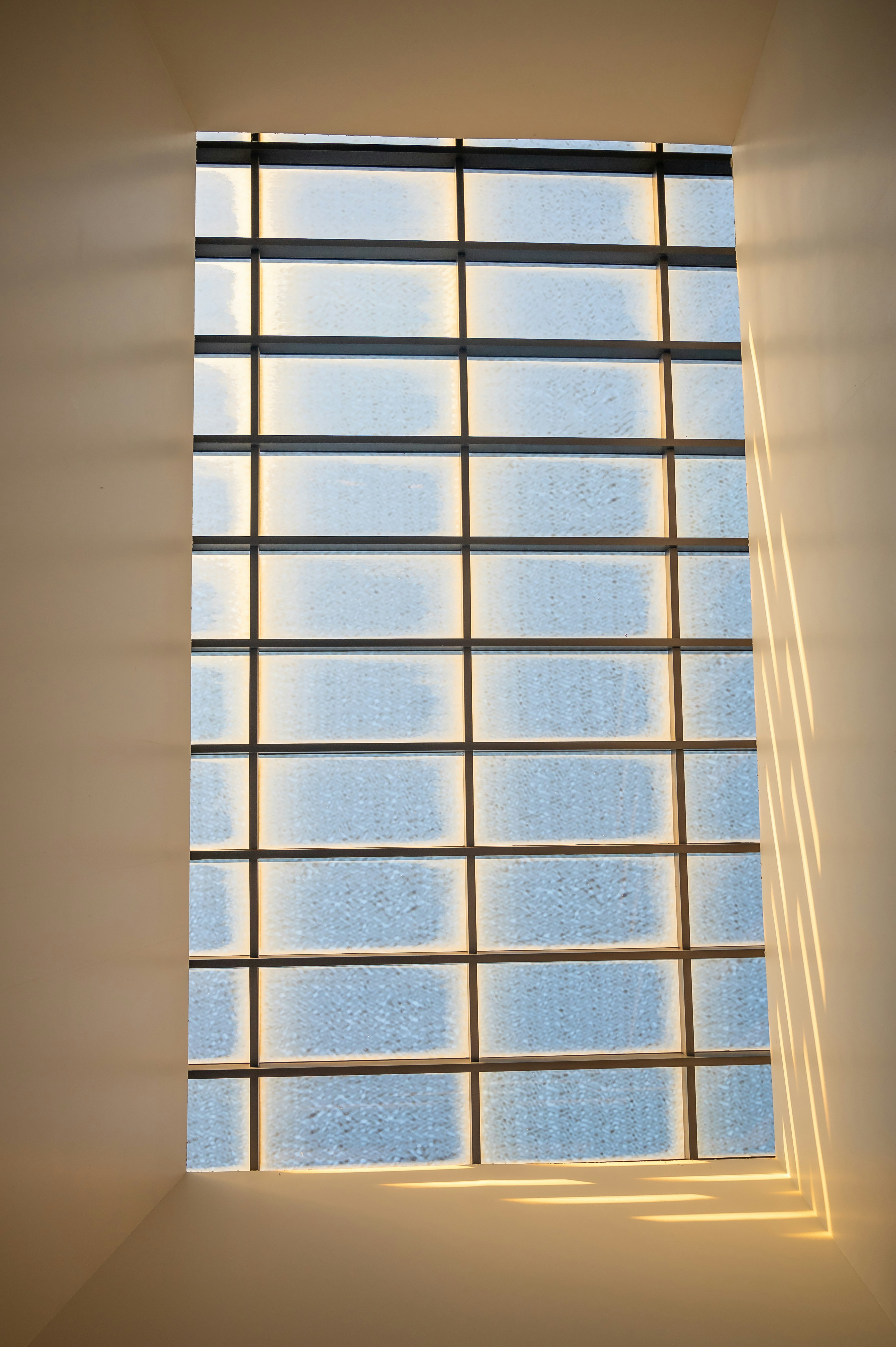 a room with a large window and a skylight